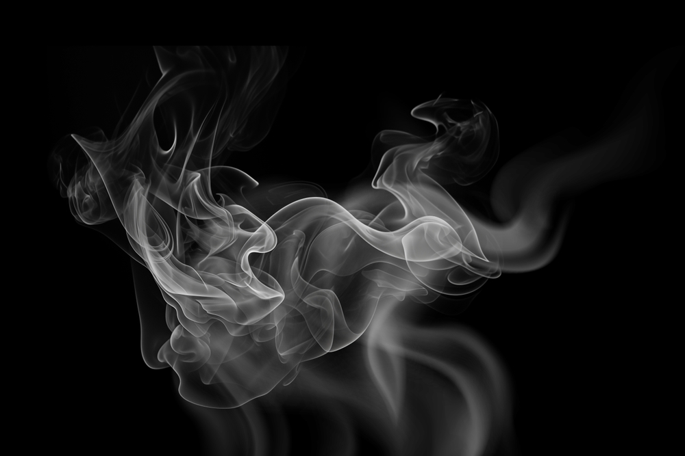 puff of smoke enlarged upon a black background