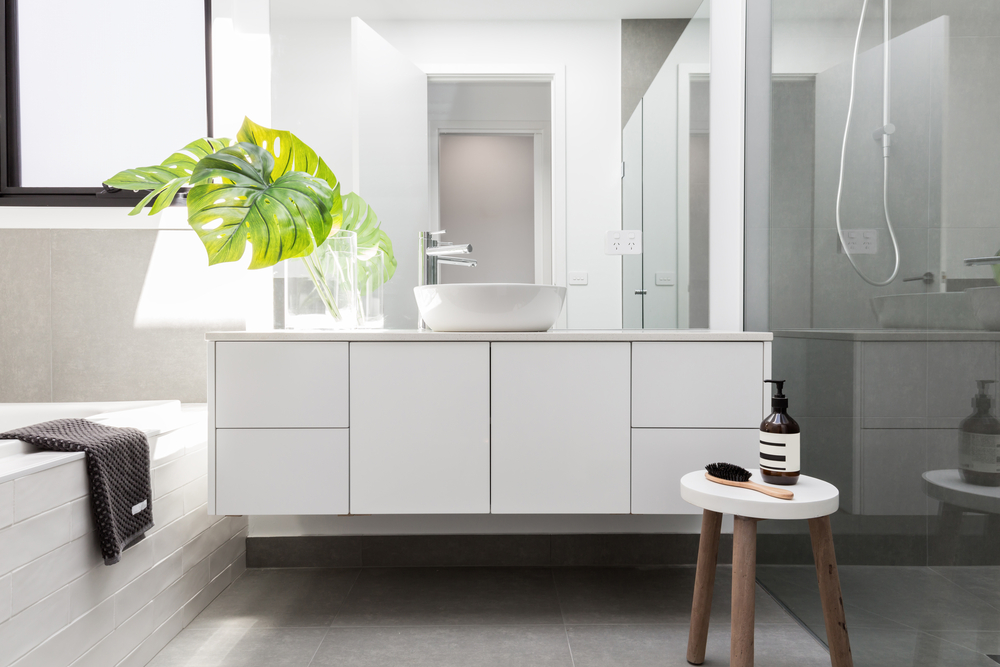 photo of white wall mounted sink, faucet, and cabinet